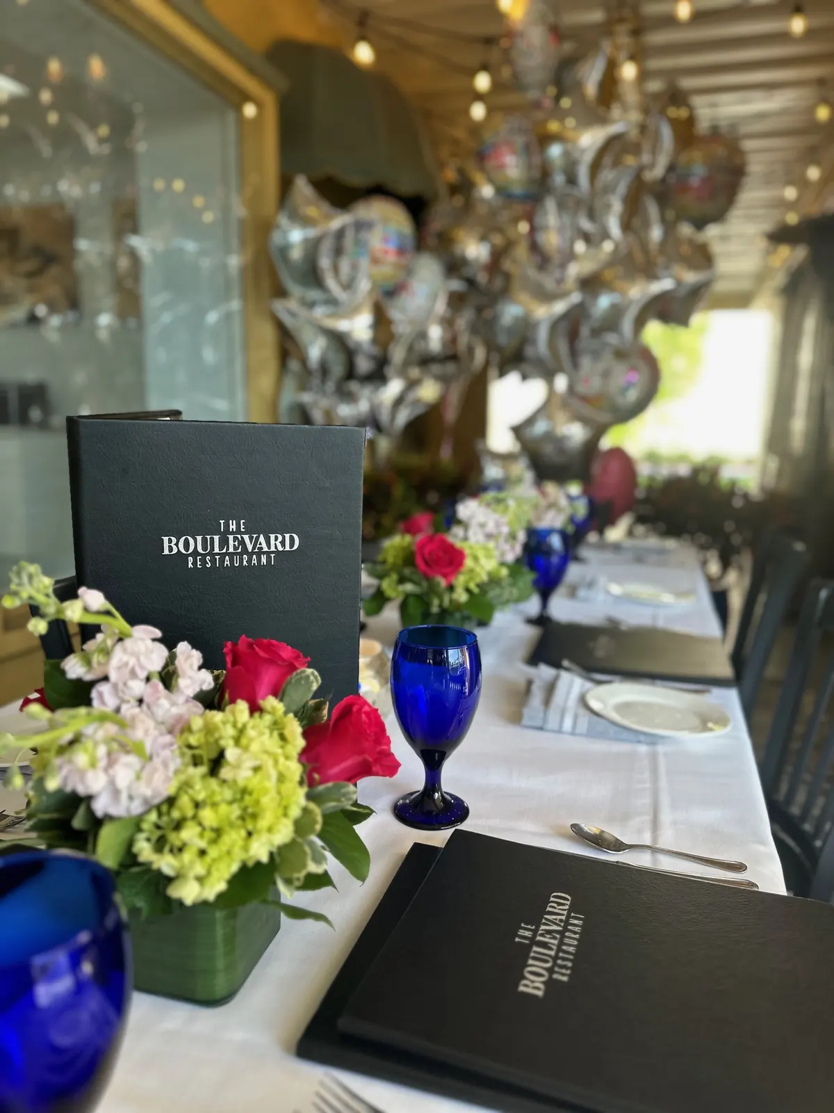 A table with fresh flowers and blue glasses
