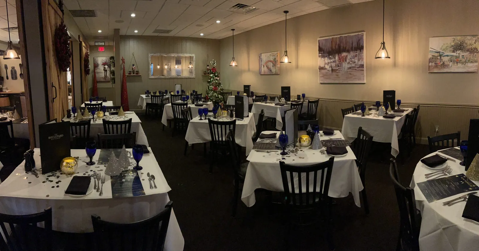The Boulevard dining room with white tablecloths and blue glasses
